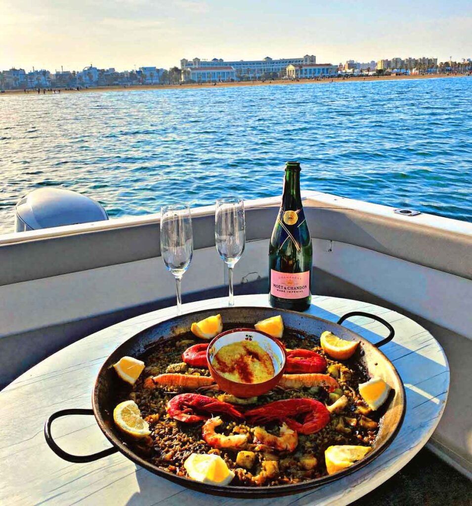 Enjoy a paella on board our boat rental service.