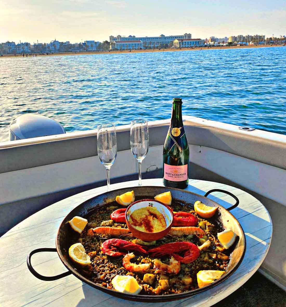 Enjoy a paella on board our boat rental service.